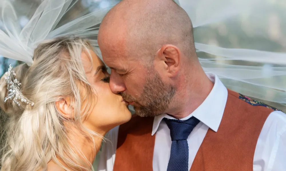 Katie and Craig sharing a kiss beneath the veil at Mount Pleasant Hotel, Doncaster